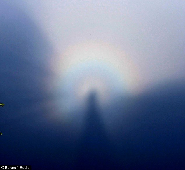 A ’Buddha Halo’ appears after rain on Huang Mountain in Huangshan, Anhui province of China  Read more: http://www.dailymail.co.uk/news/worldnews/article-1304709/Holy-rainbow-Rare-Buddhas-Halo-appears-mountain-China.html#ixzz0xEedNnU8