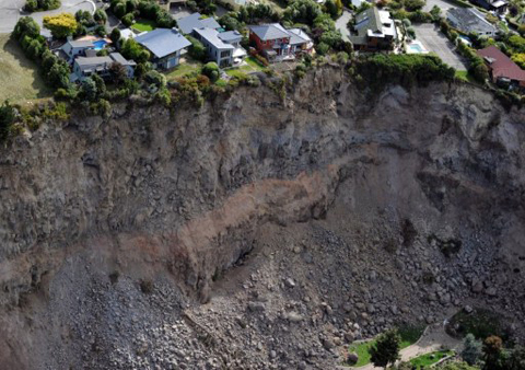 Luxury houses teeter on the edge after landslides in Redcliffs near Christchurch on February 27, 2011, after a 6.3 earthquake devastated New Zealand's second city and surrounding towns on February 22. The quake caused more damage than the 7.1 magnitude quake that hit the city on September 4, 2010 and has killed at least 146 people.