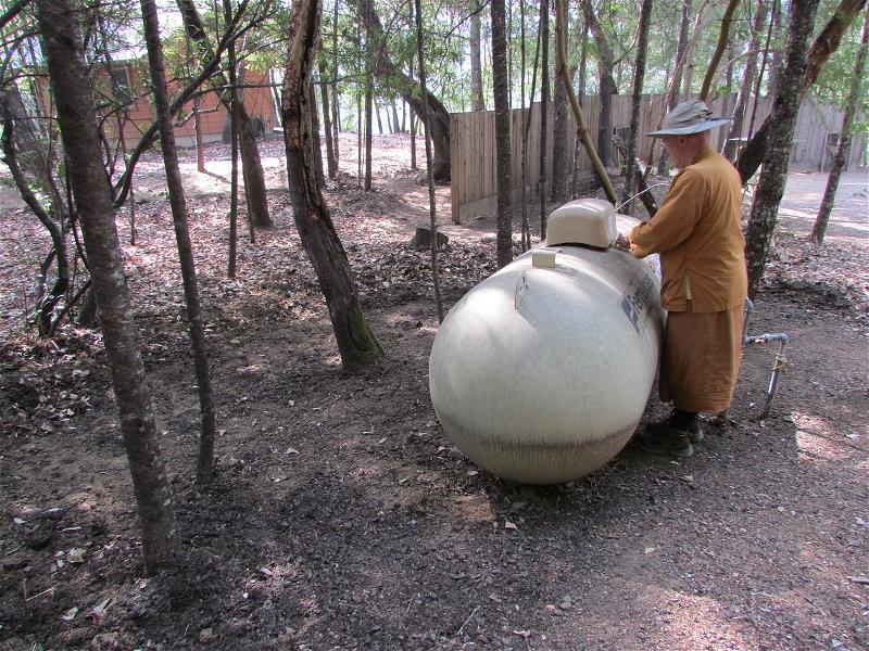 Ajahn Pasanno checking the propane tanks